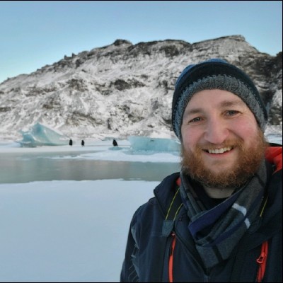 David smiling in front of a glacier in Iceland